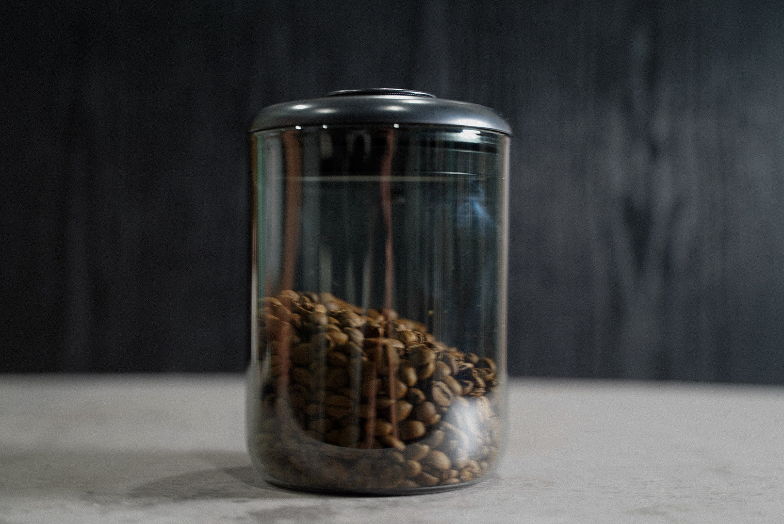 Airtight coffee storage container holding whole bean coffee