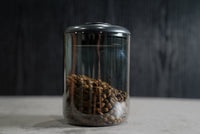Airtight coffee storage container holding whole bean coffee
